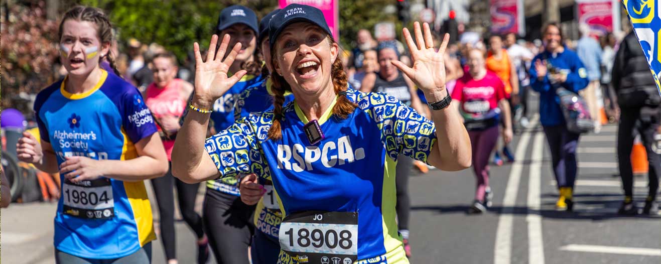 A charity runner running for the RSPCA wearing a branded running top.