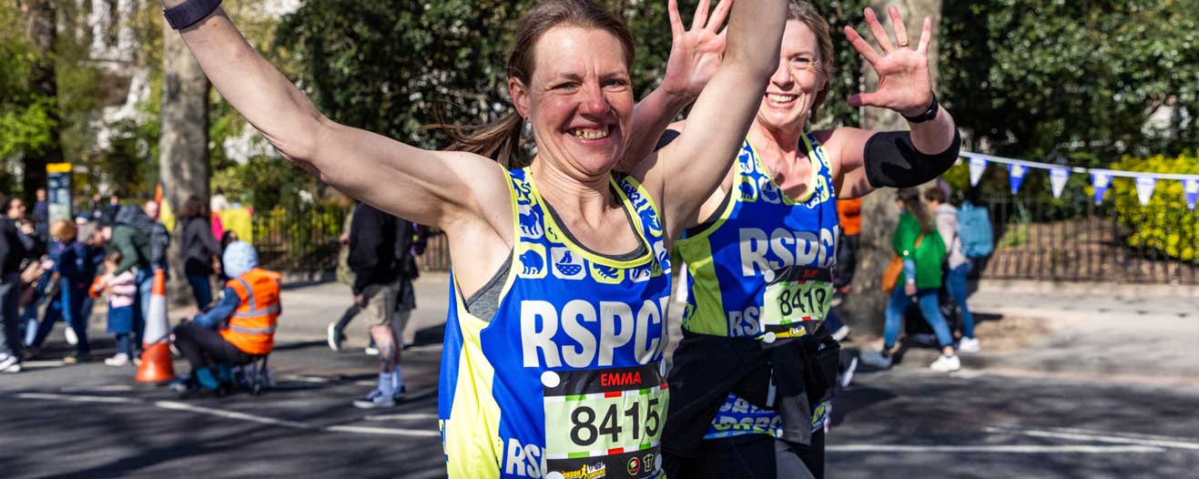 Two RSPCA fundraisers running in an organised charity run event.