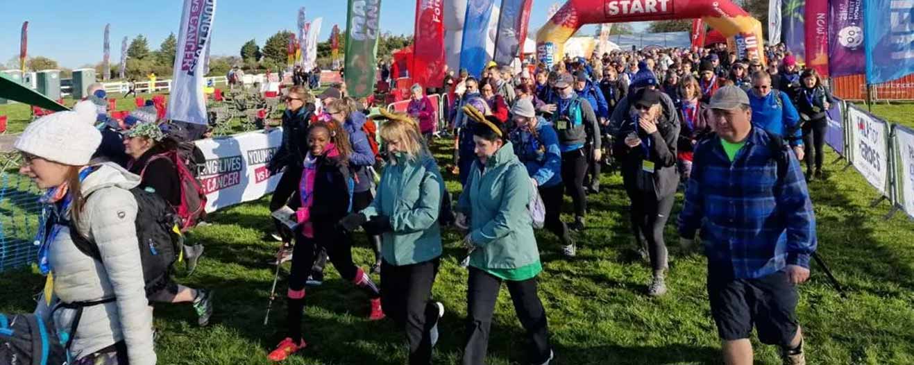 Charity walkers starting out at the start line of the Easter 50 Challenge trekking event.