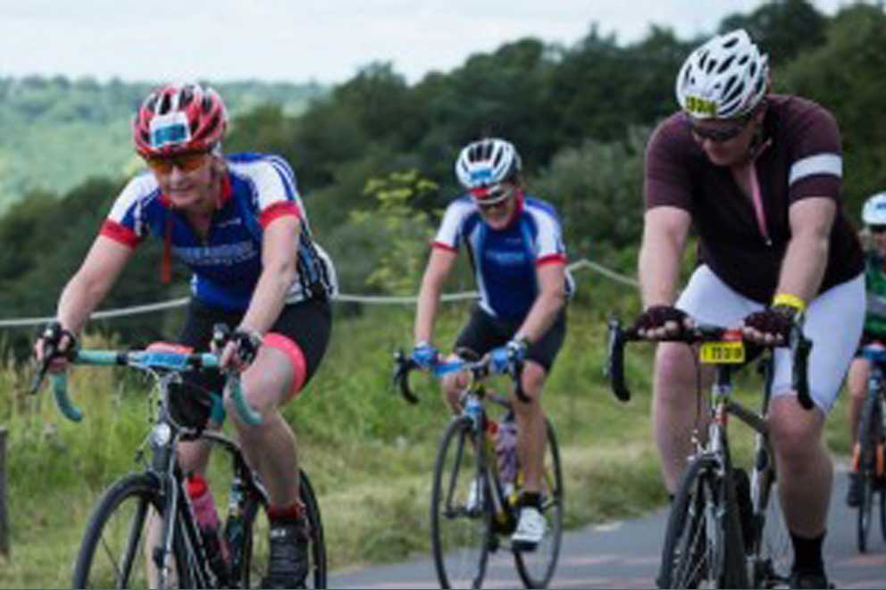 Three cyclists riding on the road as part of a cycling event.