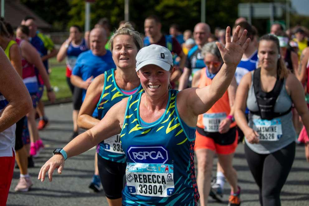 RSPCA runner passing supporters on an organised event.