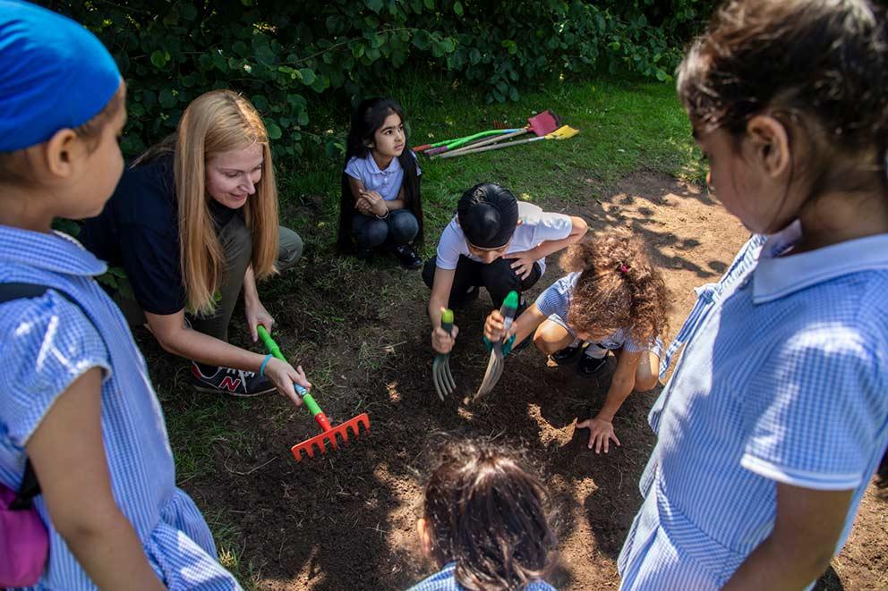 A teacher with her class outdoors.