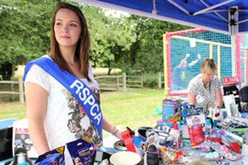 volunteer in sash at jumble sale