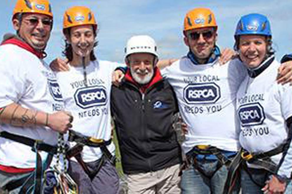 A group of people abseiling for charity.