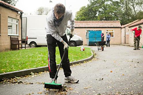 man sweeping road