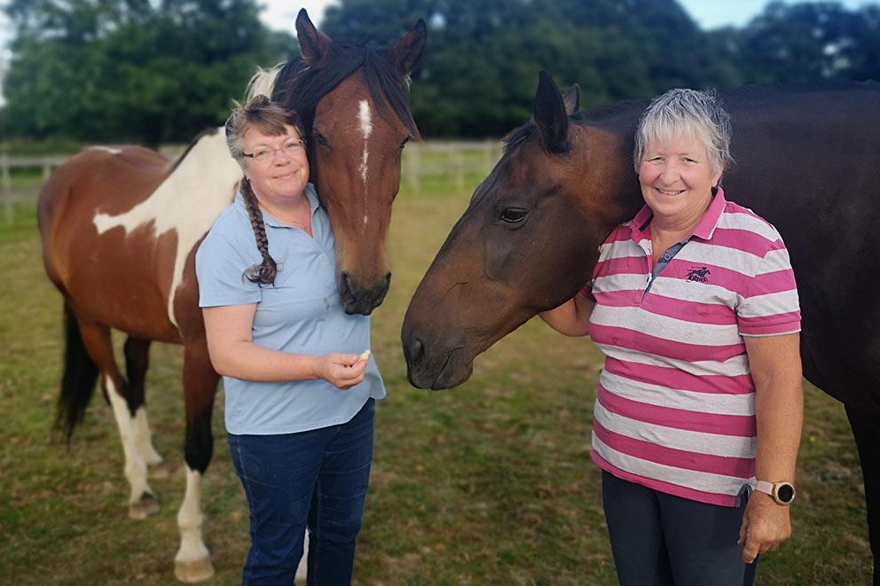 Two women with two horses