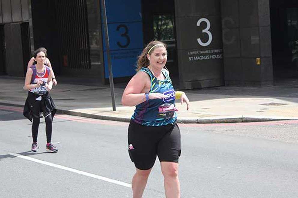 A charity runner wearing an RSPCA branded running vest while participating in an organised charity event.