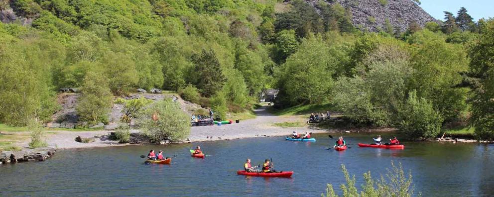 A group of kayakers in a lake in the Snowdonia National Park.
